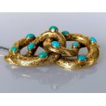 A Victorian coiled serpent gold brooch with oval turquoise and etched decoration