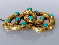 A Victorian coiled serpent gold brooch with oval turquoise and etched decoration