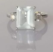 An aquamarine and diamond dress ring on a white gold setting