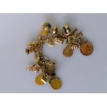 A 9ct yellow gold charm bracelet to include an Edwardian gold sovereign, 1904; George III sovereign