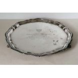 An octagonal silver tray with rope-twist border on three feet with engraved dedication