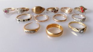 An assortment of ten 9ct gold rings, most gem-set, 23.68g; two 18ct gold rings, 6g