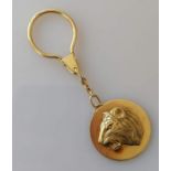 A yellow gold keyring with raised lion profile disc, hallmarked for Asprey & Co. Ltd., London 1994