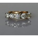 A five-stone diamond ring on a yellow gold claw setting, each diamond approximately 0.50 carats