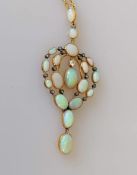 An Edwardian gold framed brooch with oval opal and diamond decoration