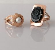 An oval black onyx cameo ring, head 25 x 15mm, and a pearl ring, both on yellow gold