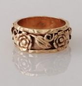 A vintage yellow gold band with applied rose decoration, size M, stamped 14k, 6g
