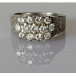 A vintage diamond cluster ring on a textured white gold setting