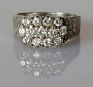 A vintage diamond cluster ring on a textured white gold setting