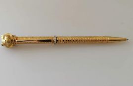 A yellow gold textured ballpoint pen with applied tiger head and diamond girdle