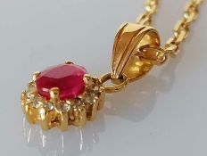 A ruby and diamond oval pendant, 6mm, stamped 585. 0.71g and a yellow gold chain