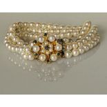 A three-strand cultured pearl bracelet with 9ct yellow gold and sapphire clasp