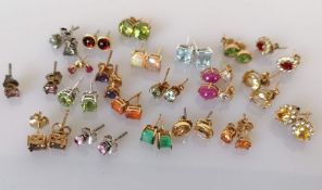 An assortment of twenty-one pairs of gem-set stud earrings, all in a 9ct gold setting, all hallmarke