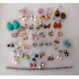 An assortment of costume jewellery comprising 35 pairs of earrings, a ring, pendant
