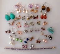 An assortment of costume jewellery comprising 35 pairs of earrings, a ring, pendant 