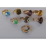 An assortment of seven gem-set dress rings on yellow gold settings, all stamped and test for 14ct go