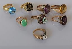 An assortment of seven gem-set dress rings on yellow gold settings, all stamped and test for 14ct go