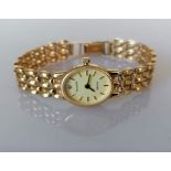 An ladies Accurist Gold quartz dress watch with oval champagne dial, baton markers