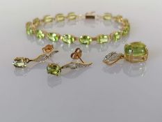 A peridot and gold parure comprising line or tennis bracelet, 16 cm, with matching pendant 