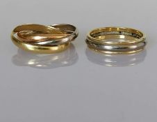 A tri-gold Russian-style wedding ring, with three interlocking bands in rose, white and yellow gold,