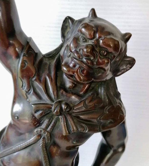 A Japanese bronze figure of Oni, modelled supporting a lotus-form candle stand, moulded signature - Image 2 of 4