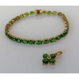 An emerald and gold line or tennis bracelet, 19 cm, with matching pendant, hallmarked 9ct, 9.3g (2)