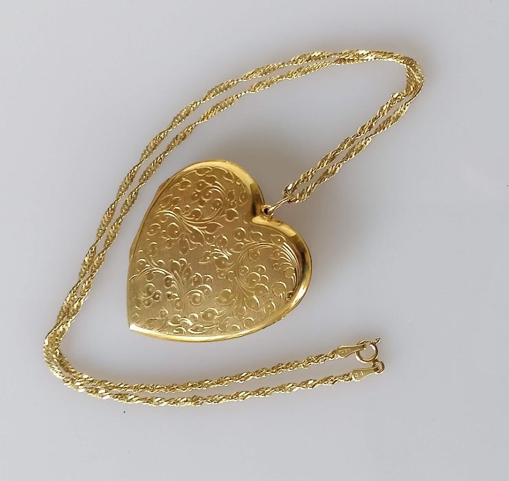 A 9ct yellow gold heart-shape locket, hallmarked, 12g and a 14k gold neck chain, 44 cm, 3.8g