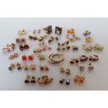 Thirty-three pairs of gem-set gold earrings, all hallmarked/stamped 9ct, 53g