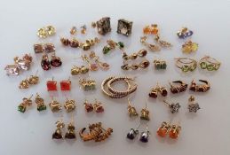 Thirty-three pairs of gem-set gold earrings, all hallmarked/stamped 9ct, 53g