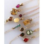 An assortment of eleven gem-set pendant chains on 9ct gold settings, all hallmarked, 25g (11)