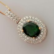 An oval Russian diopside and diamond pendant chain by Iliana, on an 18ct yellow gold setting