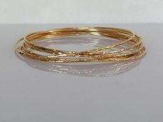 Seven yellow gold bangles with bamboo texture decoration, 60mm, each stamped 14k, 15.8g