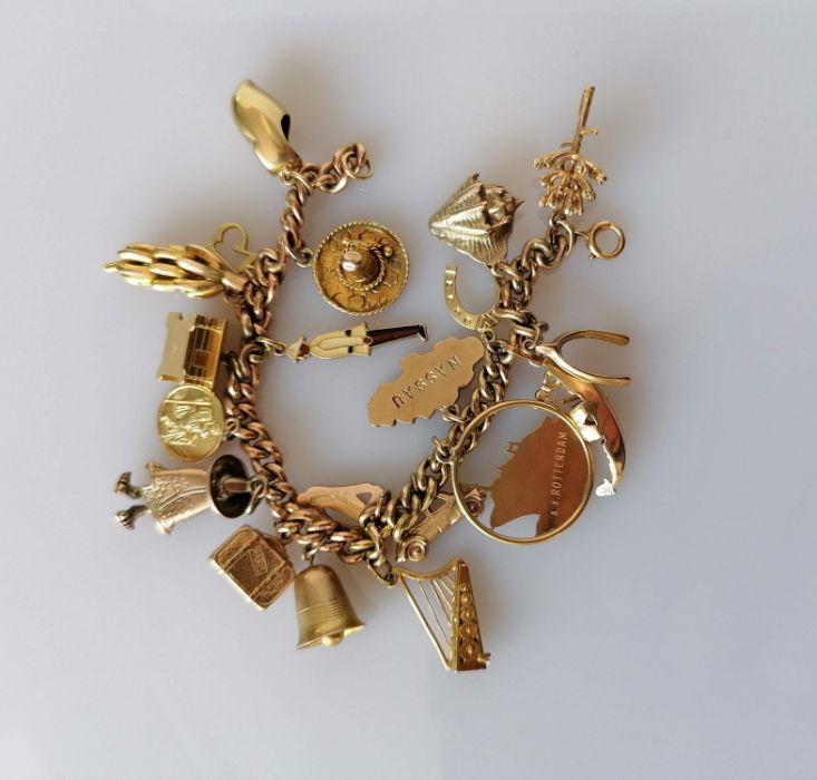 A gold charm bracelet, all hallmarked 9ct, 48.8g