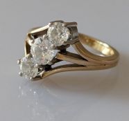 A three-stone diamond ring in a gold claw setting, centrally set with one old European-cut diamond