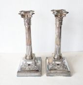 A pair of late Victorian silver candlesticks modelled as Corinthian columns 