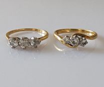 A graduated three-stone diamond ring on a yellow gold claw setting