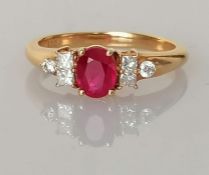 An 18ct yellow gold ruby and diamond ring by Iliana in a claw setting