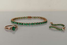 A 9ct yellow gold line or tennis bracelet with oval emeralds (each 3, 2mm) and box clasp