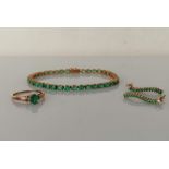 A 9ct yellow gold line or tennis bracelet with oval emeralds (each 3, 2mm) and box clasp