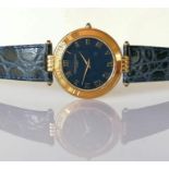 A Pierre Balmain unisex gold-cased quartz watch with black round face, Roman numerals