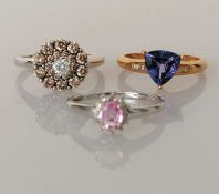 Three 14ct gold rings: a diamond cluster ring on a white gold claw setting,