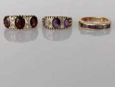 A three stone garnet gold ring; a similar amethyst ring, (stones not matching)