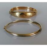 A 9ct yellow gold hinged bangle with etched floral decoration of tapering form, and another