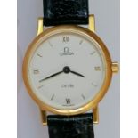 A ladies Omega De Ville 18ct gold wristwatch with round champagne dial with applied gilt numerals an