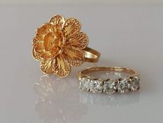 A five-stone diamond ring on a yellow gold claw setting, each diamond approximately 0.20 carats