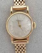 An International Watch Co. ladies manual dress watch with raised baton markers, champagne dial, 17mm