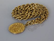 An Italian yellow gold rope-twist neck chain with disc pendant, 54 cm, hallmarked 750