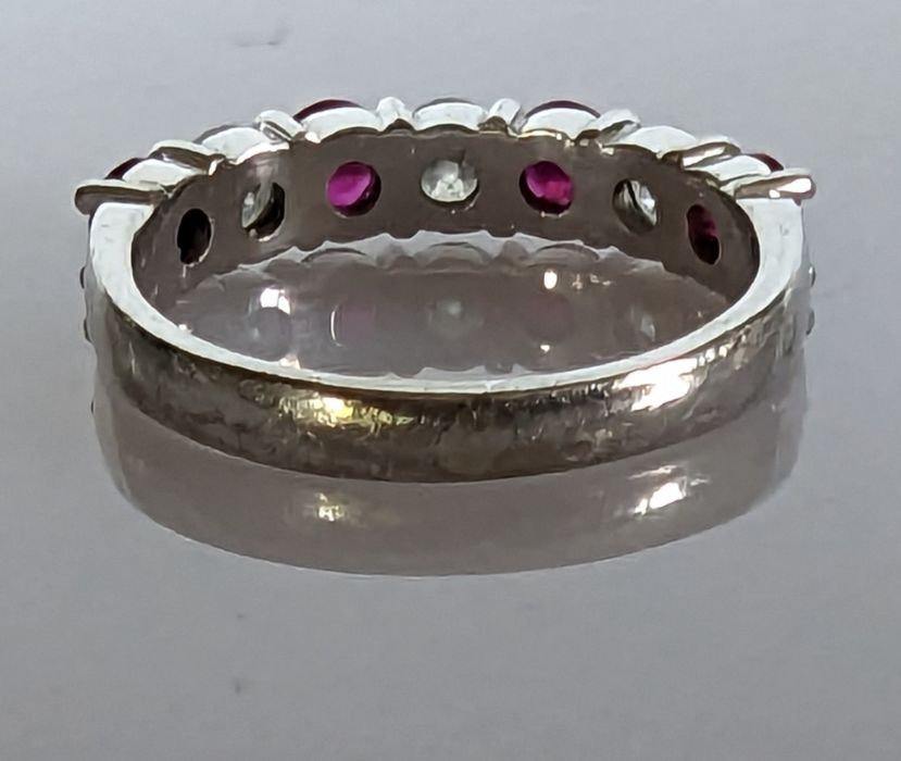An 18ct white gold ruby and diamond seven-stone half-hoop eternity ring in a claw setting - Image 5 of 5