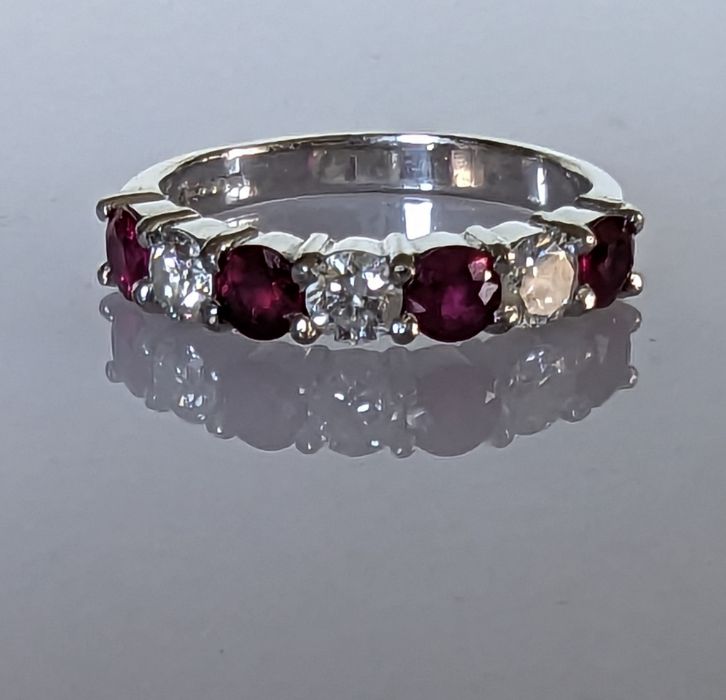 An 18ct white gold ruby and diamond seven-stone half-hoop eternity ring in a claw setting - Image 2 of 5