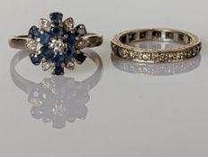 A mid-century sapphire and diamond cluster ring on a white gold setting and a diamond eternity ring